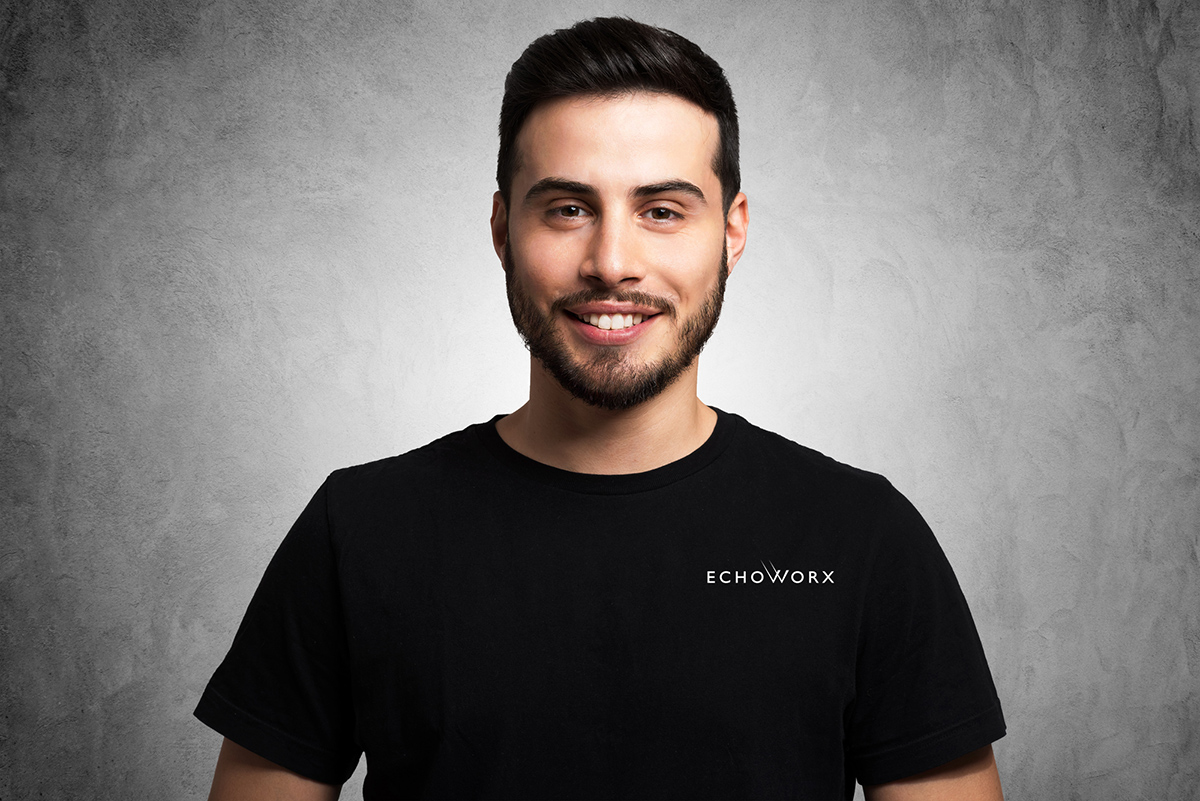 Smiling man wearing Echoworx t-shirt