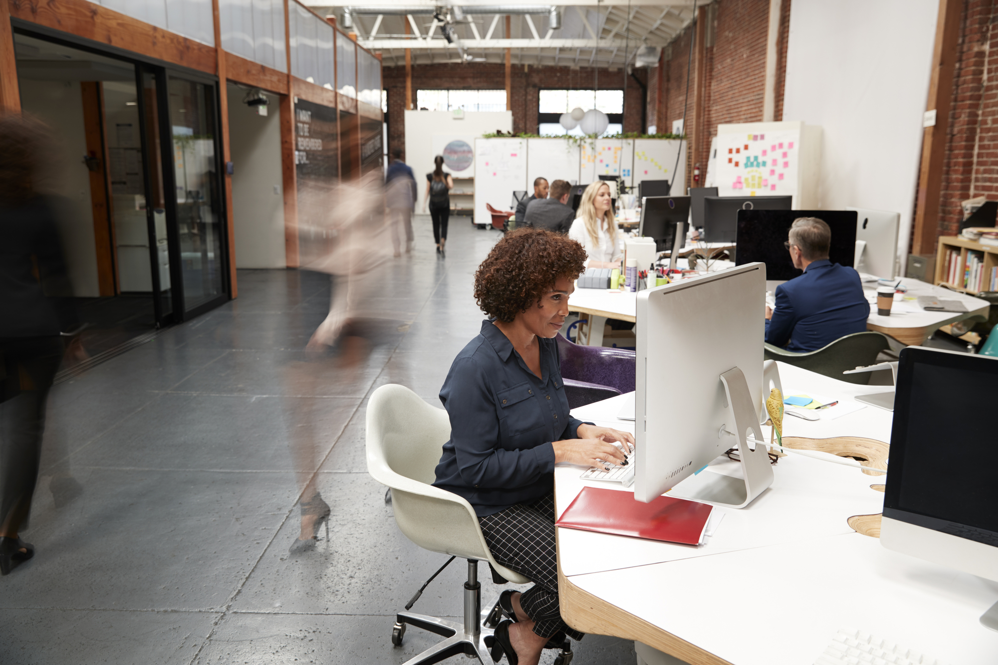 Business Team Working At Desks In Modern Open Plan Office